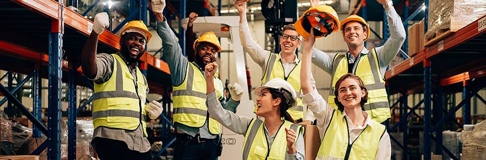 A group of happy multiethnic warehouse workers cheering